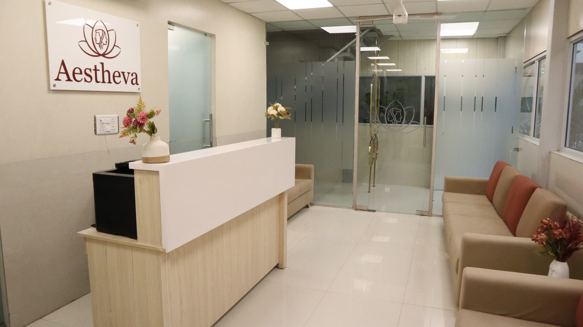 Clinic reception with branded glass doors